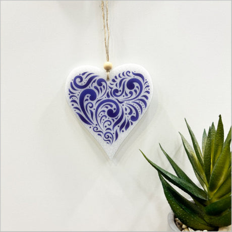 Elegant hanging heart ornament with intricate laser-cut designs, perfect for home decor or thoughtful gifts.