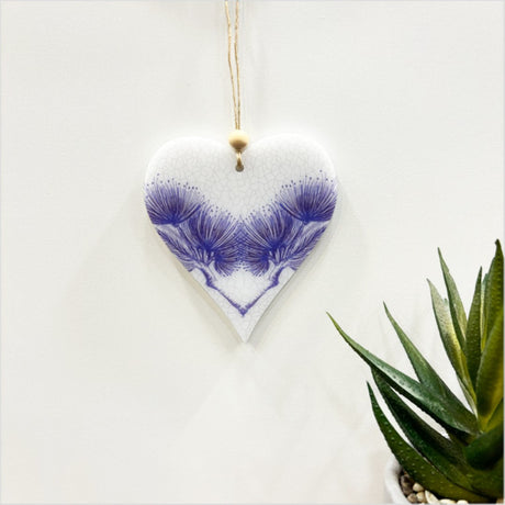 Laser cut satin acrylic heart ornament featuring Pohutukawa design, ready to hang, 95mm x 105mm.