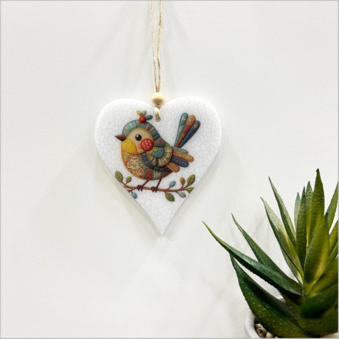 Elegant heart-shaped hanging ornament featuring a bird design, crafted from 6mm satin acrylic, perfect for home decor.