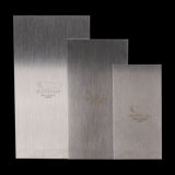 Set of three Footprint Cabinet Scrapers, high carbon steel, designed for precise wood finishing and shaping.