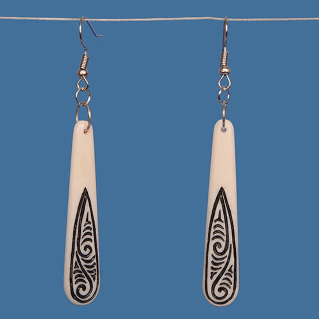 Handcrafted drop earrings made of bone, featuring black tribal patterns and shiny silver hooks, lightweight and stylish.