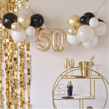 Elegant champagne noir balloon bunting for 50th birthday celebrations, perfect for indoor or outdoor decor.