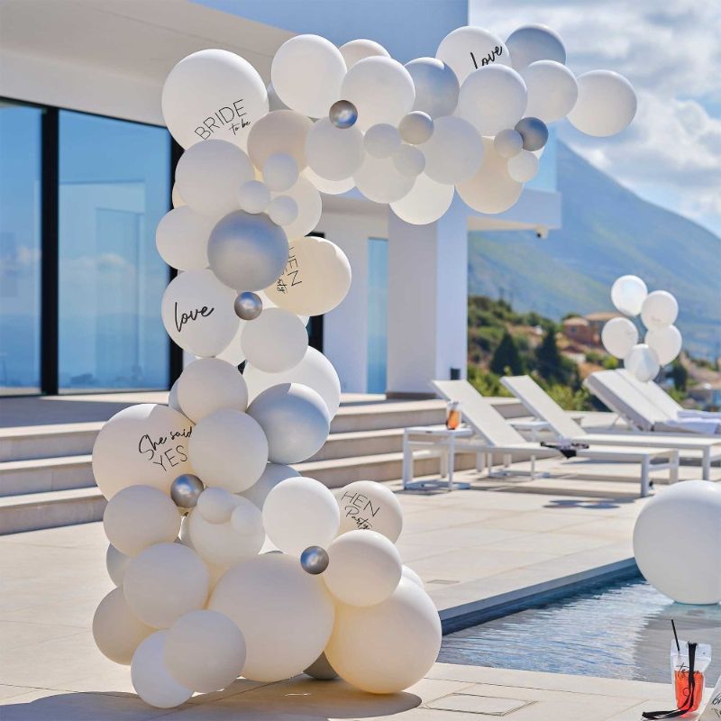 Elegant white and silver balloon arch kit for hen parties, featuring 75 balloons for a festive atmosphere.