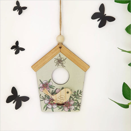 Intricate Green Manuka birdhouse wall art in vibrant hues, made from laser-cut pine on durable MDF, ready to hang.