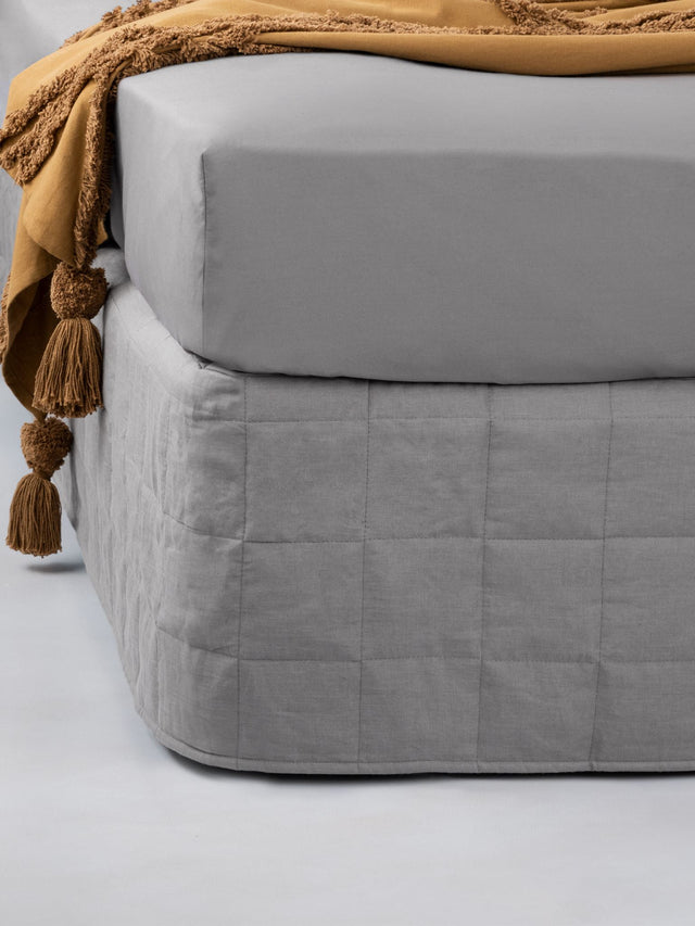 Luxurious king-size quilted valance in Nimes Ash, blending elegance with a natural linen texture and versatile neutral tone.