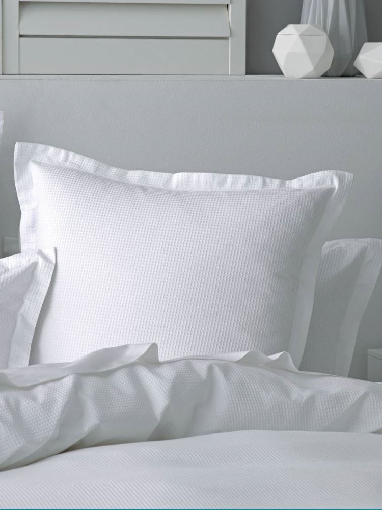 Queen duvet set in white featuring luxurious waffle texture, includes duvet cover and two pillowcases for elegant comfort.