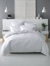 Californian King duvet cover set in white with cotton waffle front, tailored flange, and percale reverse for luxurious comfort.