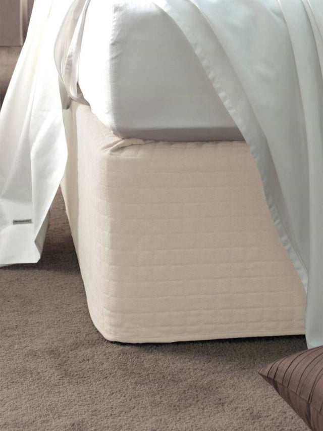 Cream suede quilted bedwrap for single beds, enhancing bedroom decor with elegance and durability.