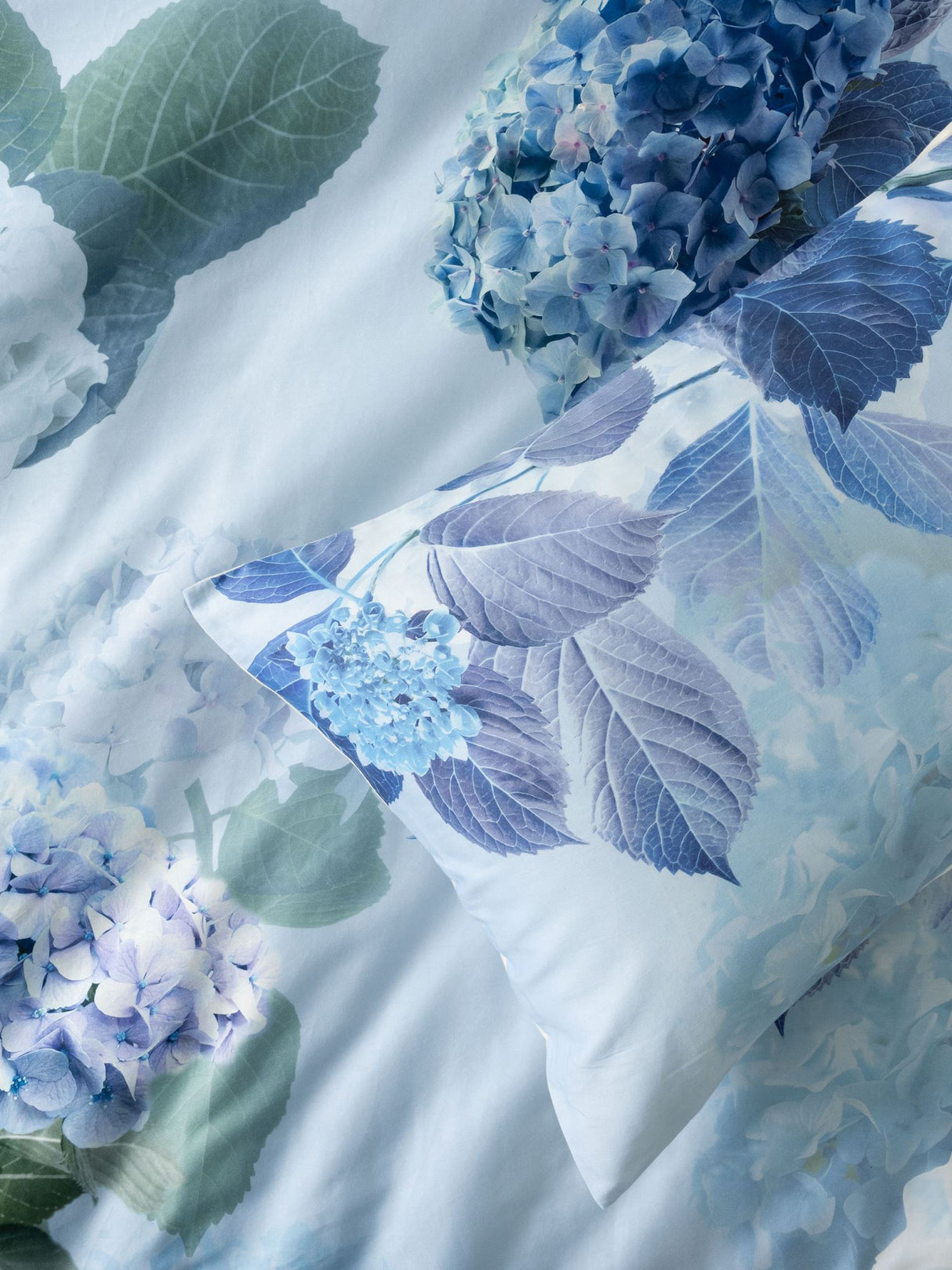 Thea Duvet Cover Set in sage with floral hydrangea pattern, 100% soft cotton for Queen beds, includes two matching pillowcases.