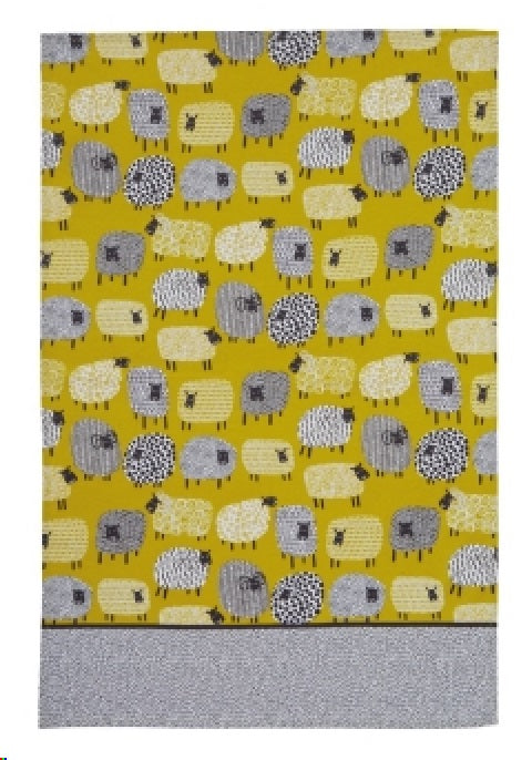 Cotton tea towel featuring a playful dotty sheep design, perfect for drying dishes and enhancing kitchen decor.