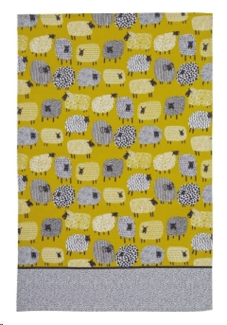 Cotton tea towel featuring a playful dotty sheep design, perfect for drying dishes and enhancing kitchen decor.