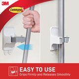 Command Broom Gripper 17007 hanging a broom, designed for tidy storage with no damage to walls or surfaces.