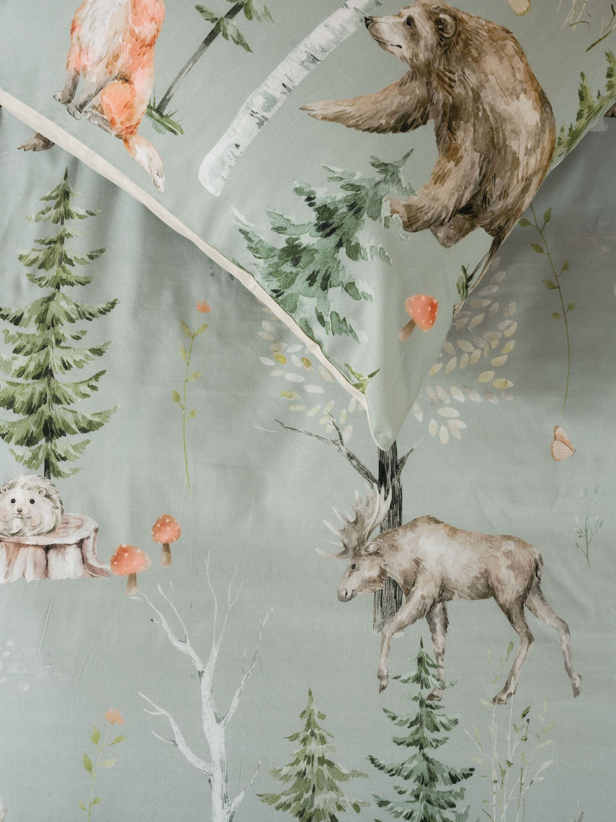 Single duvet cover set featuring hand-painted bears, foxes, and deer on a sage green background by Squiggles.