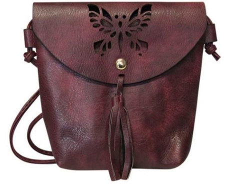 Dusky rose leather-look shoulder bag with butterfly cut-out and tassel, zip closure, and back pocket.