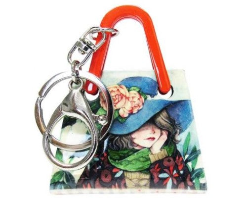 Acrylic keyring featuring a stylish handbag with a cute girl wearing a blue hat, perfect for keys or handbag charm.