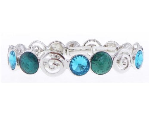 Elegant silver bracelet featuring aqua crystals and dark green circles in a unique pinwheel design.