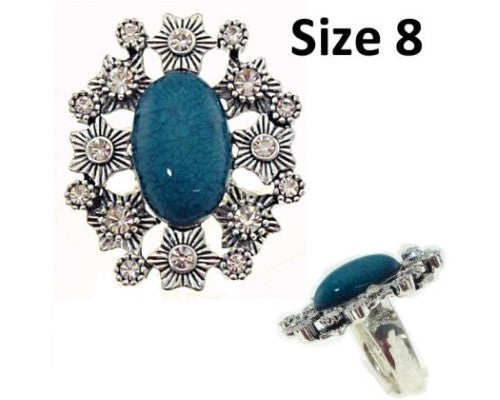 Teal ring featuring a large oval resin center surrounded by sparkling diamante, perfect for elegant occasions.