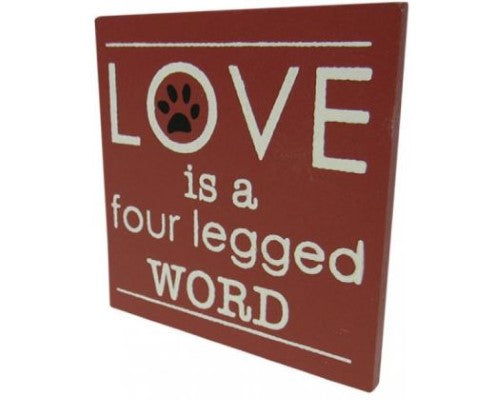 Black and white fridge magnet featuring the phrase 'Love is a four legged word', perfect for dog lovers' kitchens.