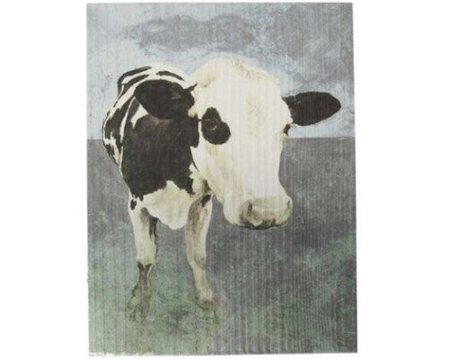 Textured wall art of a Freisian cow, showcasing rustic charm and intricate details in a monochrome palette.