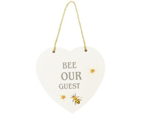 Bee heart-shaped MDF sign with 'Bee Our Guest' text, perfect for welcoming visitors with floral charm.