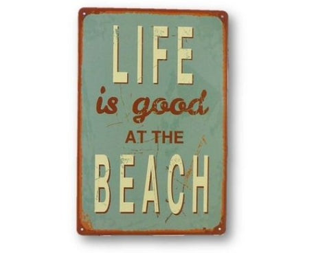 Retro Art Tin At The Beach Sign with whimsical beach artwork, perfect for coastal decor in beach houses or outdoor spaces.
