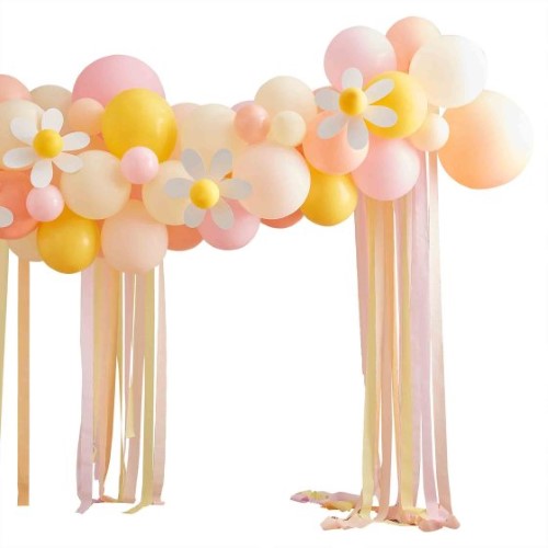 Vibrant Easter balloon arch with peach, yellow, and pink balloons, adorned with daisies and crepe streamers for festive decor.