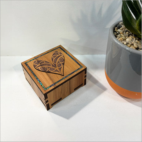 Small heart-shaped trinket box with vibrant Paua inlay, perfect for storing jewelry and cherished keepsakes.