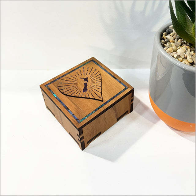 Heart-shaped square trinket box made from NZ veneer with stunning paua inlay, perfect for small treasures.