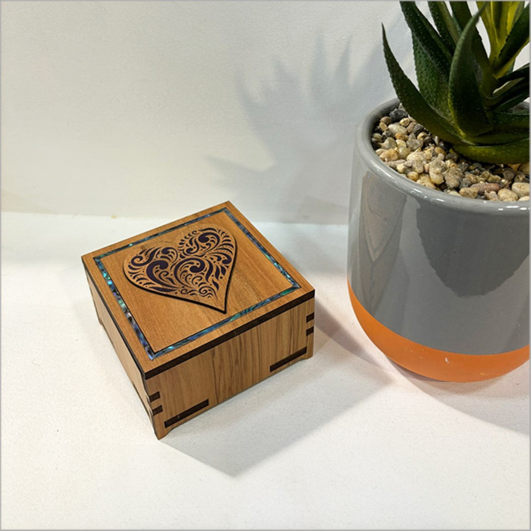 Elegant small square trinket box with paua inlay, perfect for storing jewelry and keepsakes, featuring intricate filigree design.