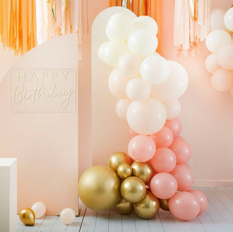 Peach and gold balloon arch kit featuring 75 balloons, perfect for weddings, parties, and special occasions.