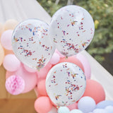 Double layered white balloons with vibrant rainbow confetti, ideal for festive celebrations and party decor.