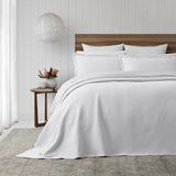 Elegant PORTO White Bedspread Set by BAKSANA, featuring stonewashed texture and eco-friendly cotton, perfect for a stylish bedroom.