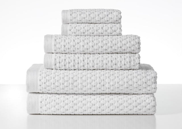 Henley Optic White Towel Bundle by BAKSANA, featuring 2 bath towels, 2 hand towels, and 2 facecloths, made from 100% cotton.