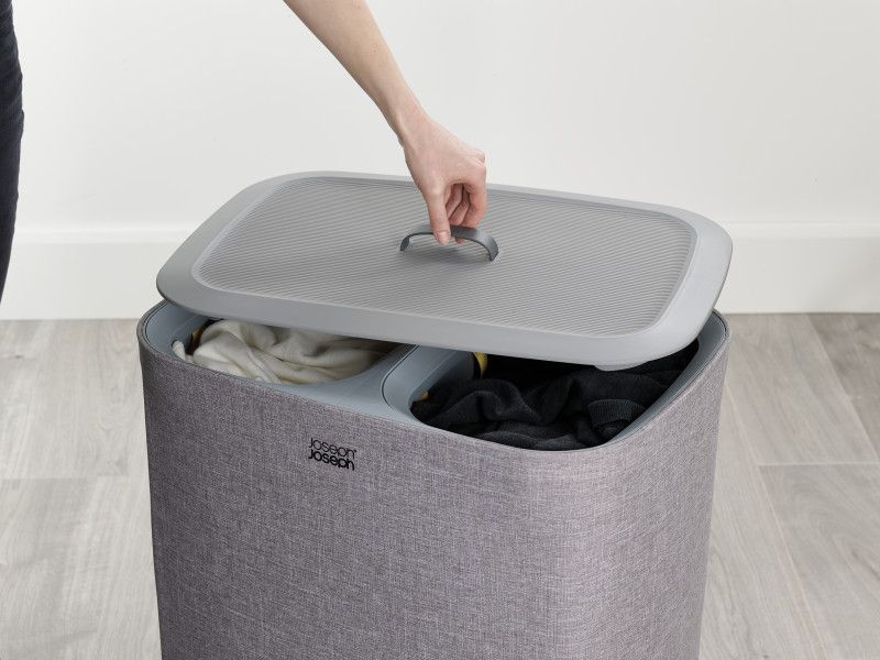 Joseph Joseph Tota 90-litre Laundry Basket in grey with two removable compartments for separating lights and darks.