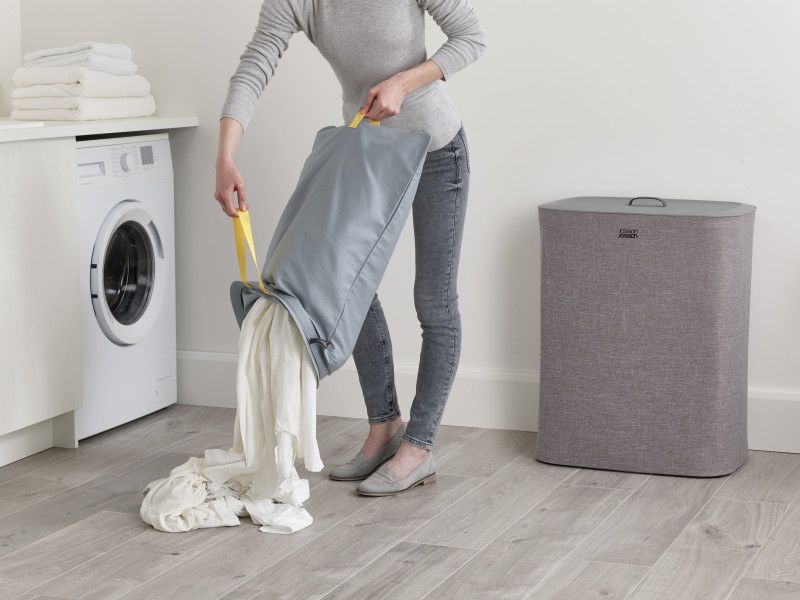 Joseph Joseph Tota 90-litre laundry basket in grey with two removable compartments for easy separation of lights and darks.